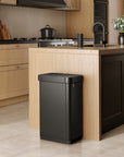 EKO trash can next to a modern kitchen counter, surrounded by light wood cabinetry and appliances.