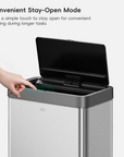 EKO Trash Can with open lid and hand pressing the "Stay Open Mode" button.