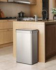 EKO trash can next to a modern kitchen counter, surrounded by light wood cabinetry and appliances.