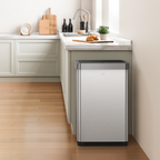 EKO stainless steel trash can in a kitchen setting with a countertop and cabinets.