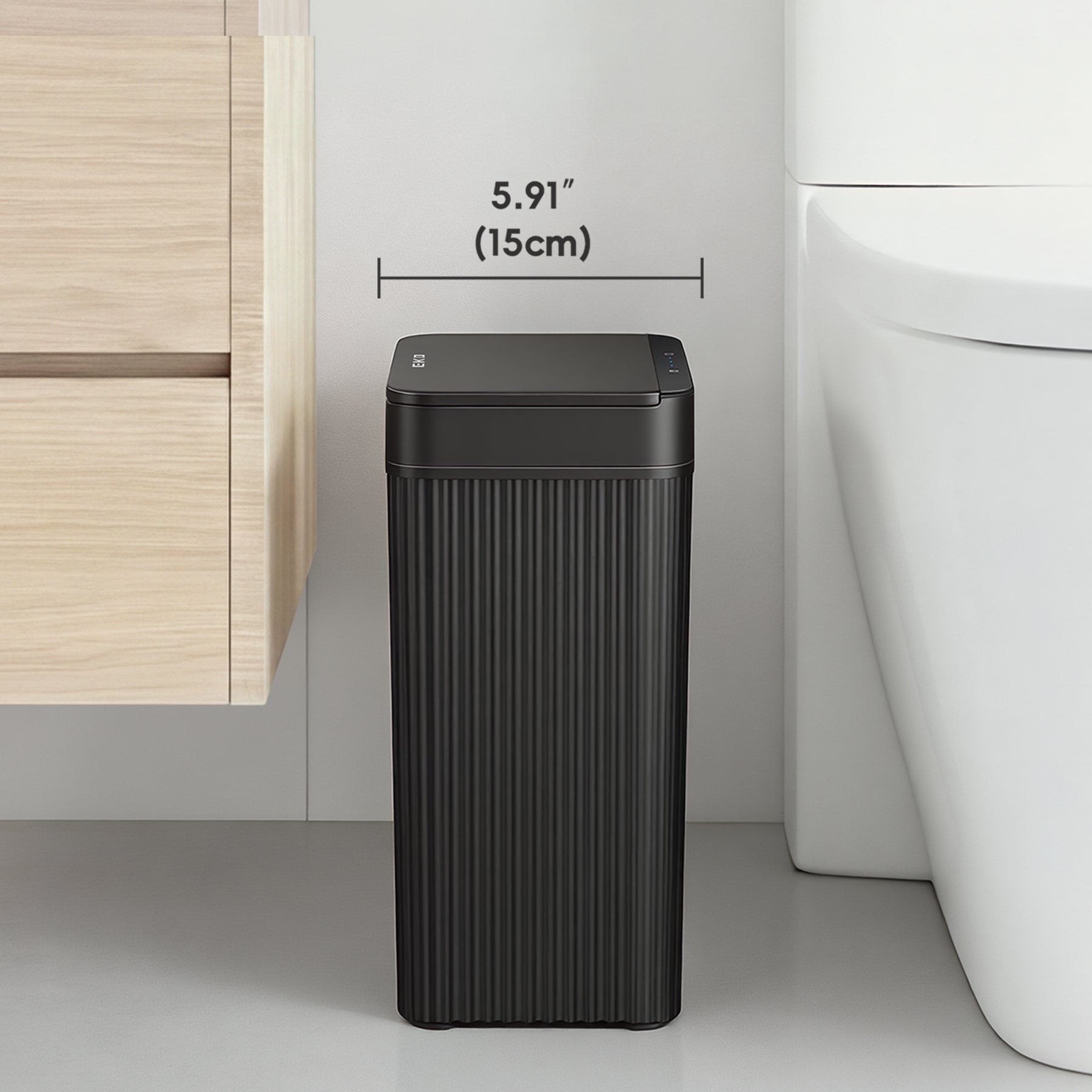 Black trash can next to a toilet with dimensions indicated