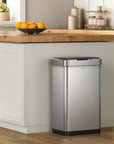 EKO stainless steel trash can in a kitchen setting with a countertop and cabinets.