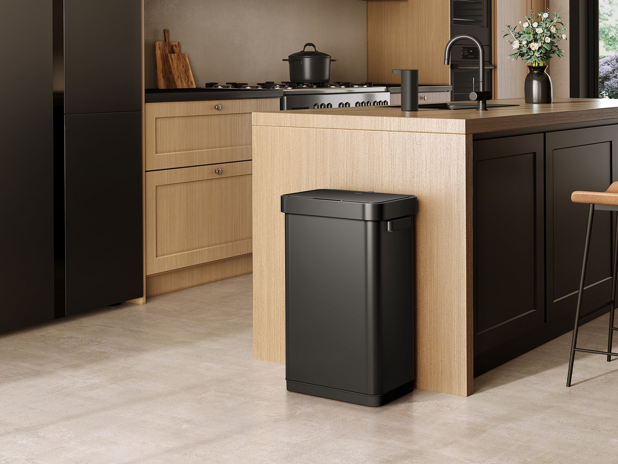 Modern kitchen with an EKO trash can in the foreground.