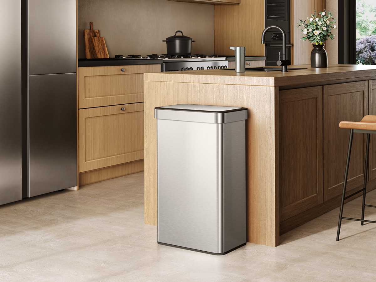 Modern kitchen with an EKO trash can in the foreground.