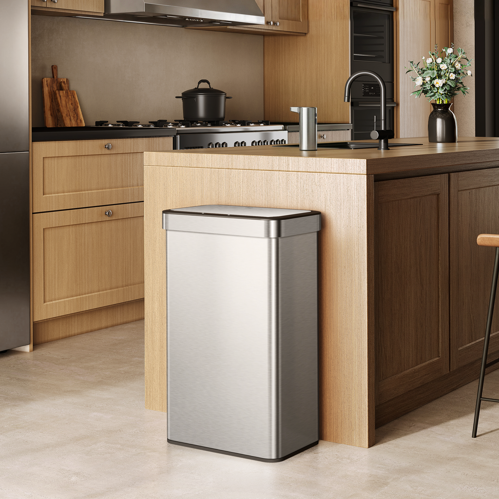 EKO trash can next to a modern kitchen counter, surrounded by light wood cabinetry and appliances.